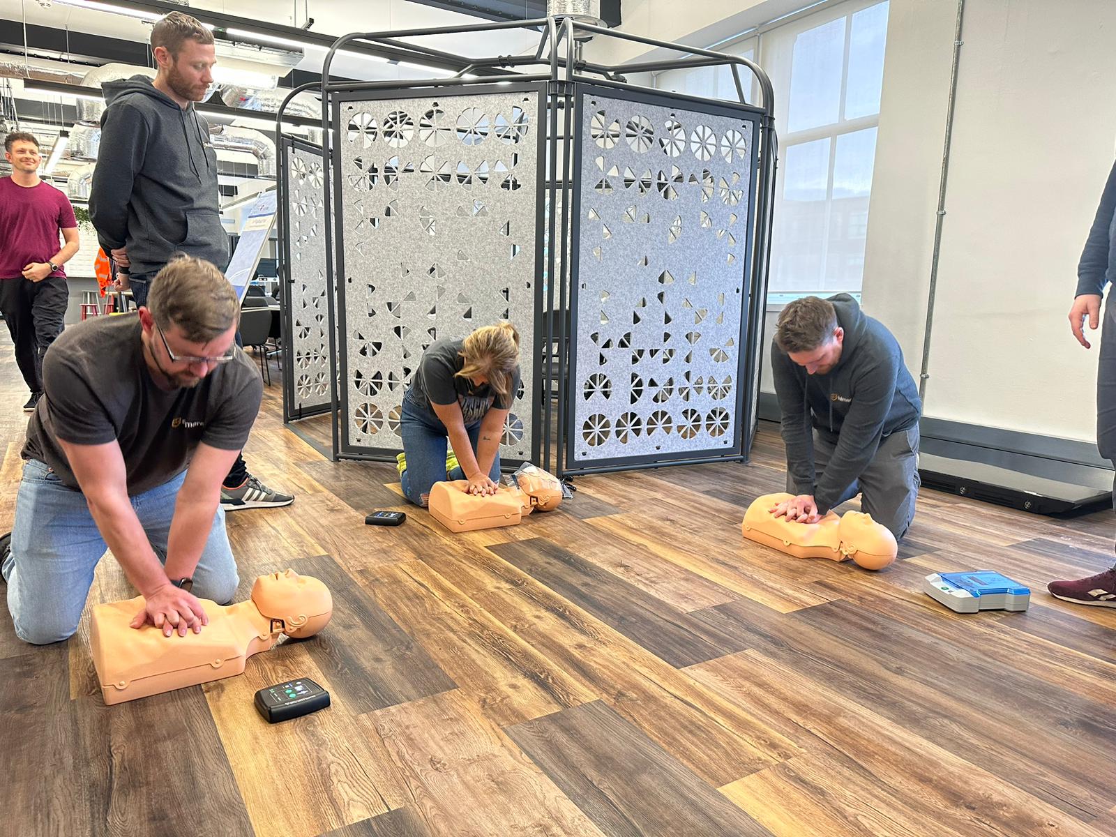 Learners practising first aid at a training session